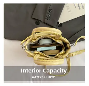 Internal capacity of yellow square bag showing daily essentials like phone and makeup