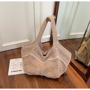 Detailed close-up of handmade woven tote bag with white scalloped edges and mesh texture