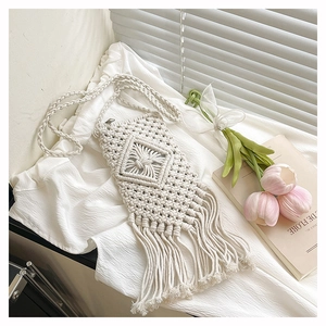 Detailed macro view of the intricate hand-woven Macrame pattern and long fringe tassels