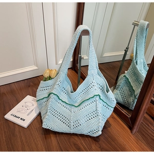 Detailed macro view of mint green hand-woven hollow tote bag with green stripe accent