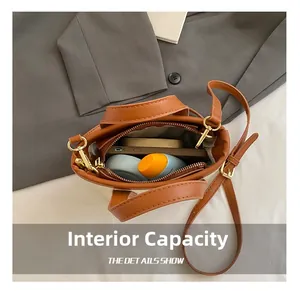 Spacious interior of a brown bucket bag showing daily items like phone and cosmetics