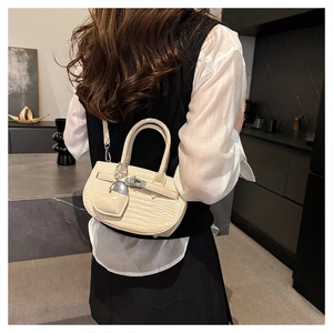Off-white crocodile texture crossbody bag with silver heart charm on female model