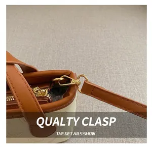 Close-up of premium gold metal hooks and textured leather on a butterfly bucket bag