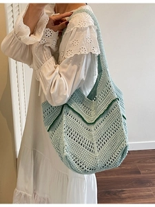 Handmade mint green crochet tote bag with contrast stripes for summer beach vacation