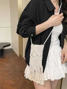 Handwoven macramé crossbody bag with fringe tassel detail for beach vacation