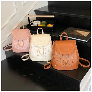 Detailed close-up of colorful mini backpacks featuring bear prints and metal chains