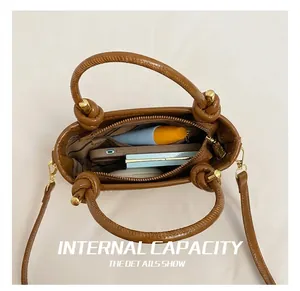Top view of woven tote bag interior showing striped lining and zip pocket with phone