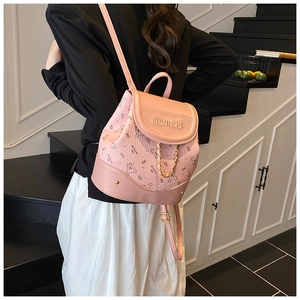 Pink mini backpack detail featuring cute bear prints and decorative gold chain accents