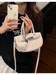 Elegant white crocodile embossed mini handbag with heart charm and metallic lock