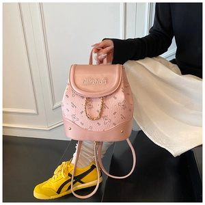 Pink PU leather mini backpack with bear pattern and gold chain detail on side view