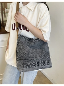Washed black denim tote bag with FASHION lettering and vintage brown woven shoulder strap
