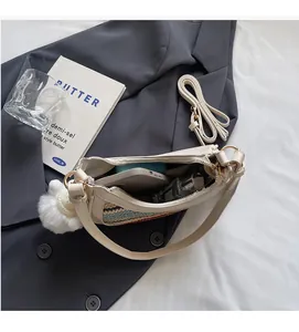 Interior view showing the storage capacity of this beige woven straw shoulder bag