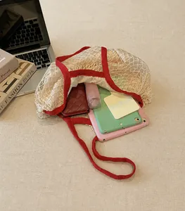 Spacious white woven cotton mesh tote bag with red strap showing large storage capacity