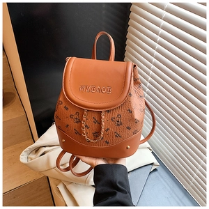 Close-up of brown faux leather mini backpack featuring bear prints and chain details