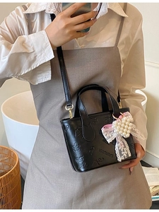 Fashionable black butterfly embossed bucket bag with pearl heart charm and lace bow