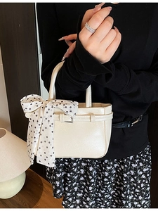 Minimalist creamy white mini square tote bag with decorative black polka dot silk scarf