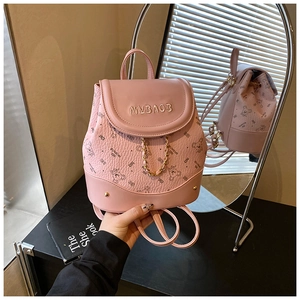 Close-up of pink mini backpack with bear print, metal chain detail and MYBAOB logo