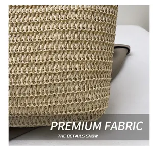 Close-up of beige woven fabric texture and brown leather trim detail on tote bag