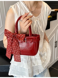 Red patent leather mini square handbag with large polka dot ribbon bow decoration