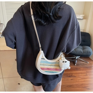 Rainbow woven straw half-moon bag detail with white faux leather trim and cute pompom charm