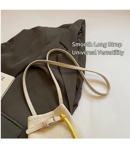 Detail of lychee pattern leather bucket bag with contrasting yellow loop and strap