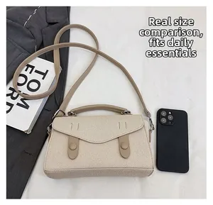 Detailed size comparison of beige woven shoulder bag next to a mobile phone