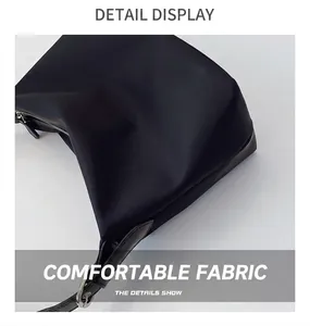 Detail view of premium black nylon fabric and silver metal buckle on a tote bag