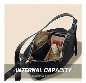 Spacious interior of a black tote bag showing capacity for phone and cosmetics