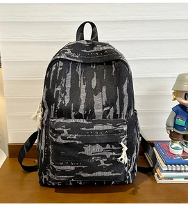 Close-up of black and white tiger stripe denim backpack with cotton rope zipper details