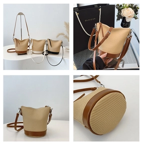 Detail view of woven straw bucket bags with leather trim and adjustable shoulder straps