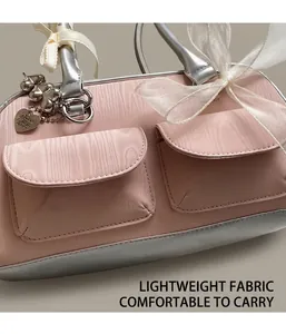 Close-up of pink saddle bag with organza bows and silver metallic heart charm detail