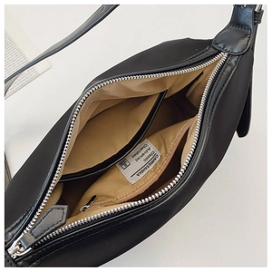 Top view showing spacious interior with khaki lining and inner pocket of the black tote bag