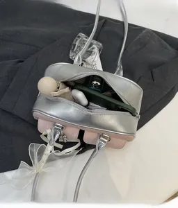 Internal view of spacious shoulder bag showing storage for phone and accessories