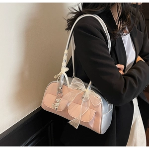 Pink and silver saddle bag with lace bow and heart charm detail shown on model