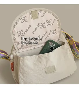 Interior view of beige nylon crossbody bag showing spacious main compartment and phone