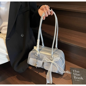 Detail of silver metallic saddle bag with ruched pockets and mesh bow accents