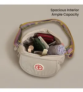 Detail of spacious interior storage for phone, wallet and umbrella in beige crossbody bag