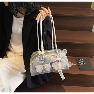 Detail of silver metallic saddle bag with white organza bows and heart charms