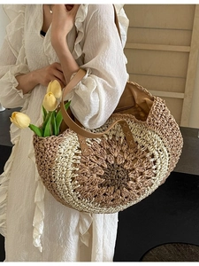 Handmade woven straw beach tote with sunflower pattern and premium leather handles