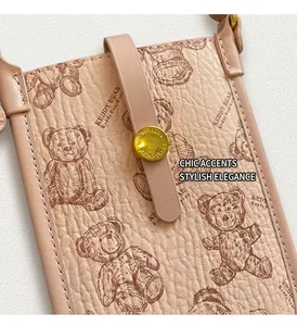 Close-up of litchi pattern leather texture with a cute teddy bear print and metal clasp
