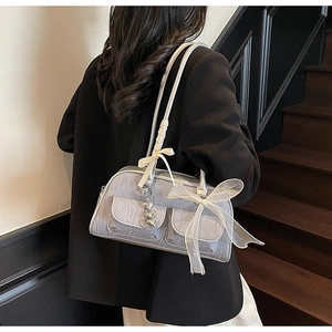 Silver-grey saddle bag with wood grain texture, organza bow, and heart charm detail