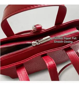 Detailed macro shot of smooth metal zipper and red crocodile embossed leather texture