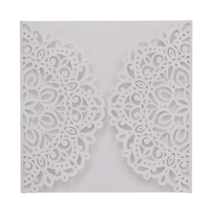 Detail showing intricate laser-cut lace mandala pattern on white wedding invitation card