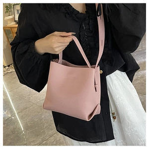 Close-up of pink litchi grain bucket bag showing the texture and MASUMII brand embossing