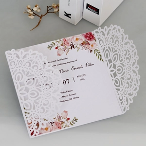 Détail d'un faire-part de mariage découpé au laser avec fleurs et papier nacré élégant