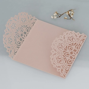 Pink laser cut wedding invitation cover with floral lace pattern on pearlescent paper