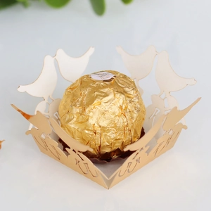 Detailed laser cut champagne gold paper candy box with elegant bird and flower lace