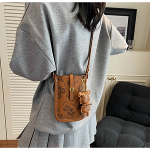 Vertical contrast color shoulder bag with teddy bear pattern and leather charm detail