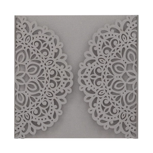 Intricate laser-cut silver lace wedding invitation cover with mandala pattern detail