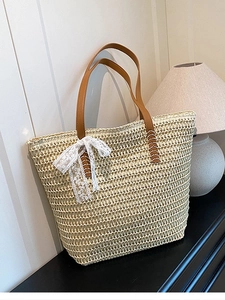 Large capacity beige straw tote bag with white lace bow and brown leather handles